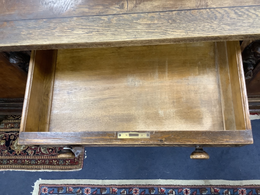 A large late 19th century oak and walnut kneehole desk, width 180cm depth 91cm height 78cm